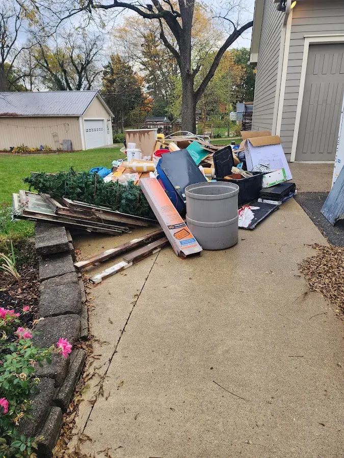 Dumpster being loaded with debris for 12 Yard Dumpster Rental in Hazlehurst